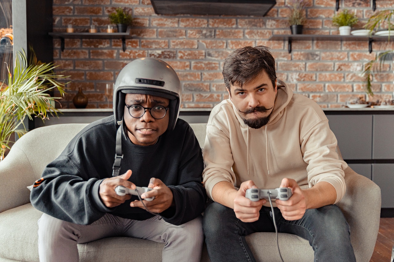 Two men are playing games on a console using multiplayers mode